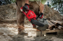 Milwaukee 14" Battery Saw - action image.